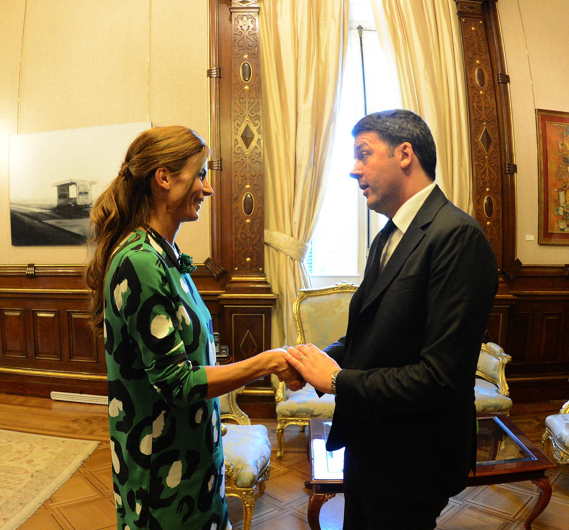 El primer ministro de Italia, Matteo Renzi, saluda a la primera dama, Juliana Awada